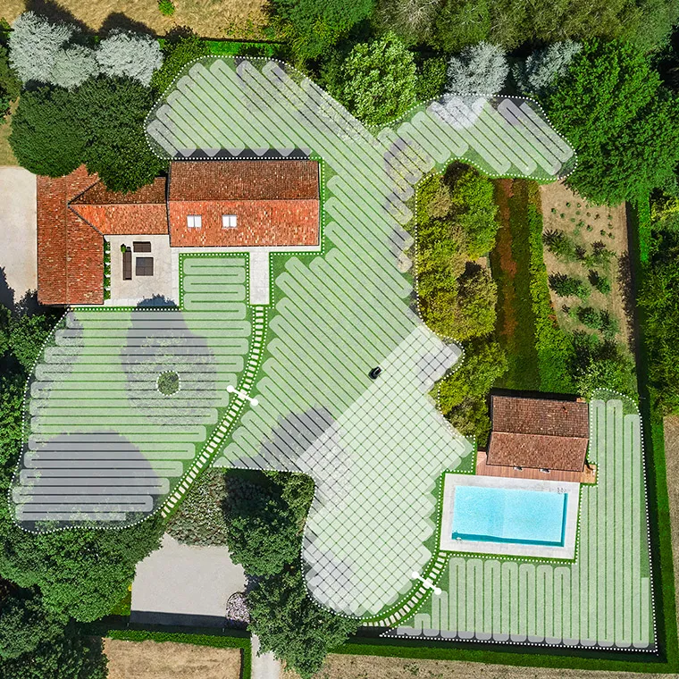 Drone view from of a house and its garden which is divided in areas that shows different mowing direction